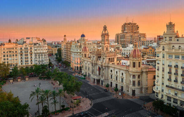 Valencia, Spain, August 19, 2018. Aerial view of the old Town Hall and its square, North Station and other historic buildings in the area, at sunset.